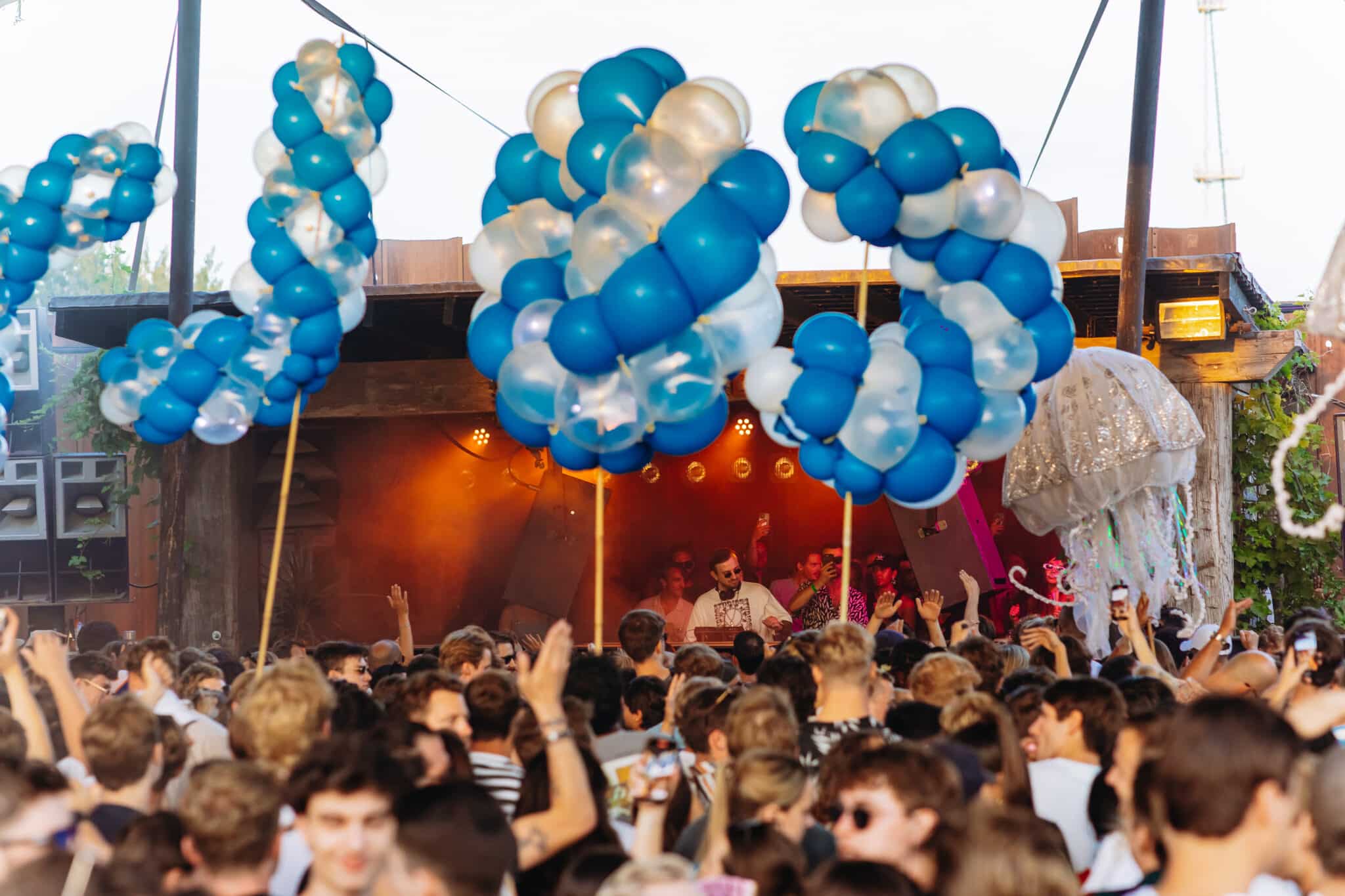 Giant blue and transparent spiral balloon letters spelling COLYN above dancing crowd at Thuishaven Amsterdam — Spellbound — Out of Thin Air — Photo by Rachel Ecclestone